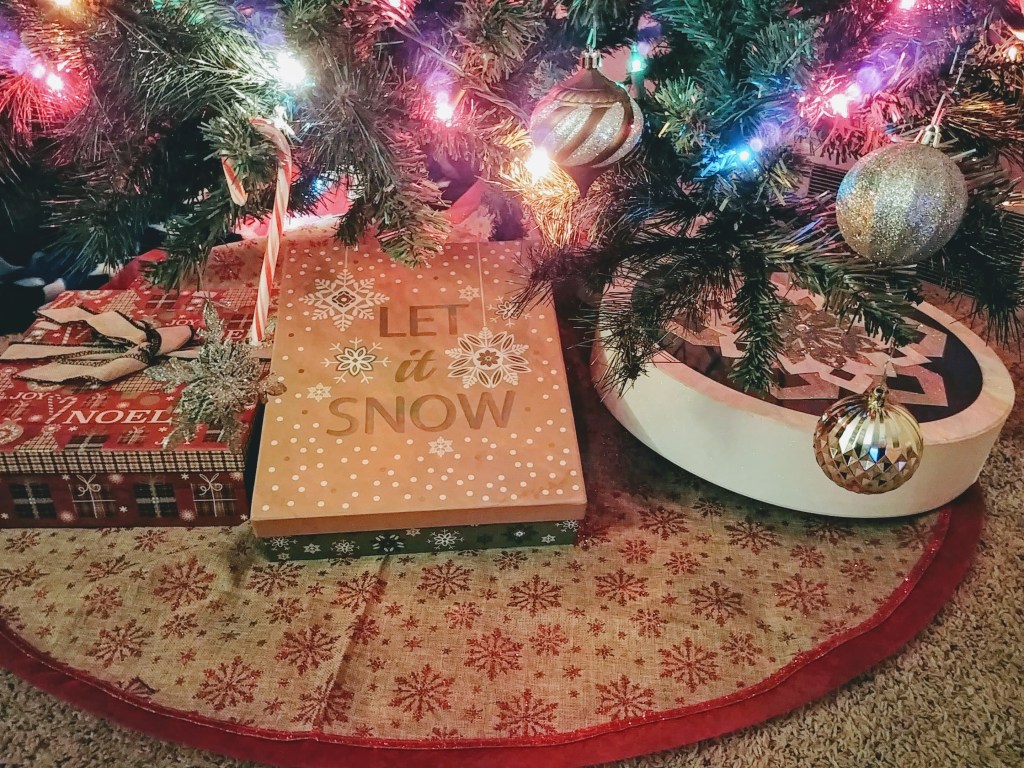 Decorative Christmas Boxes Under The Lit Christmas Tree