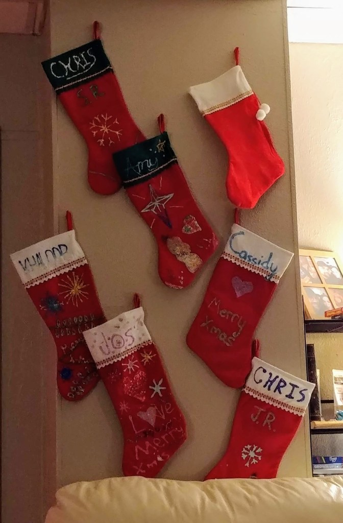 Hand Decorated Christmas Stockings hung on wall