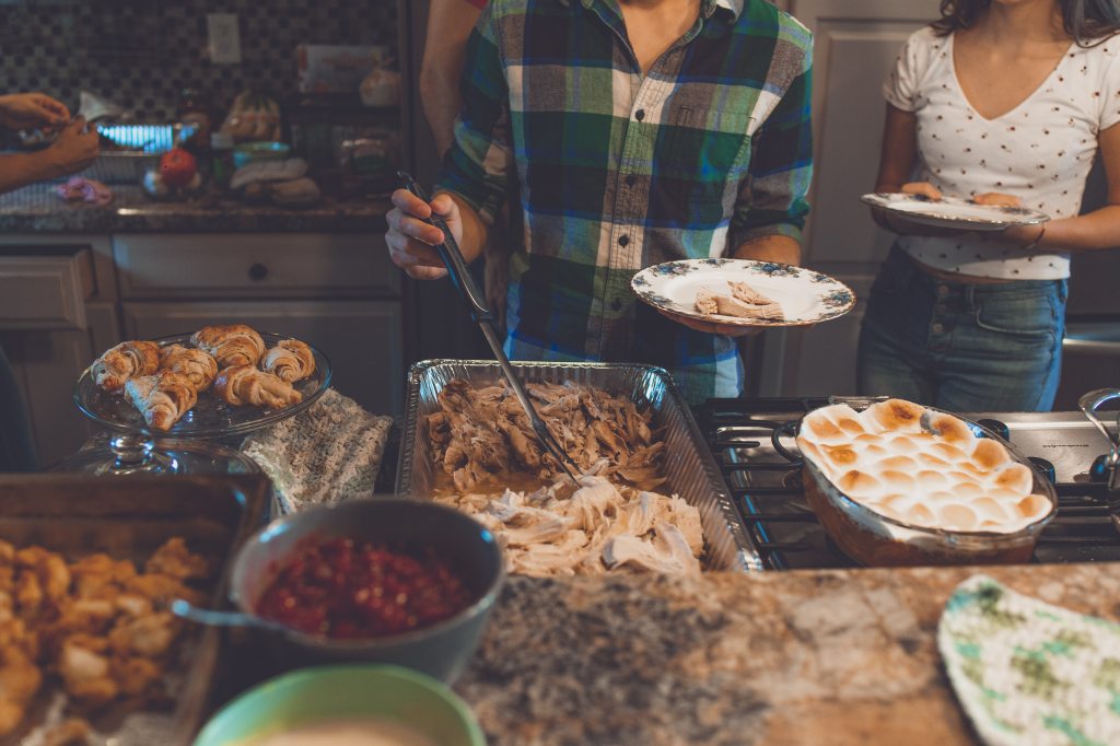 Serving food on plate from buffet