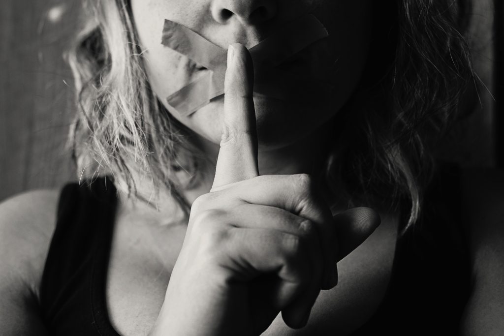 Woman with finger over her lips