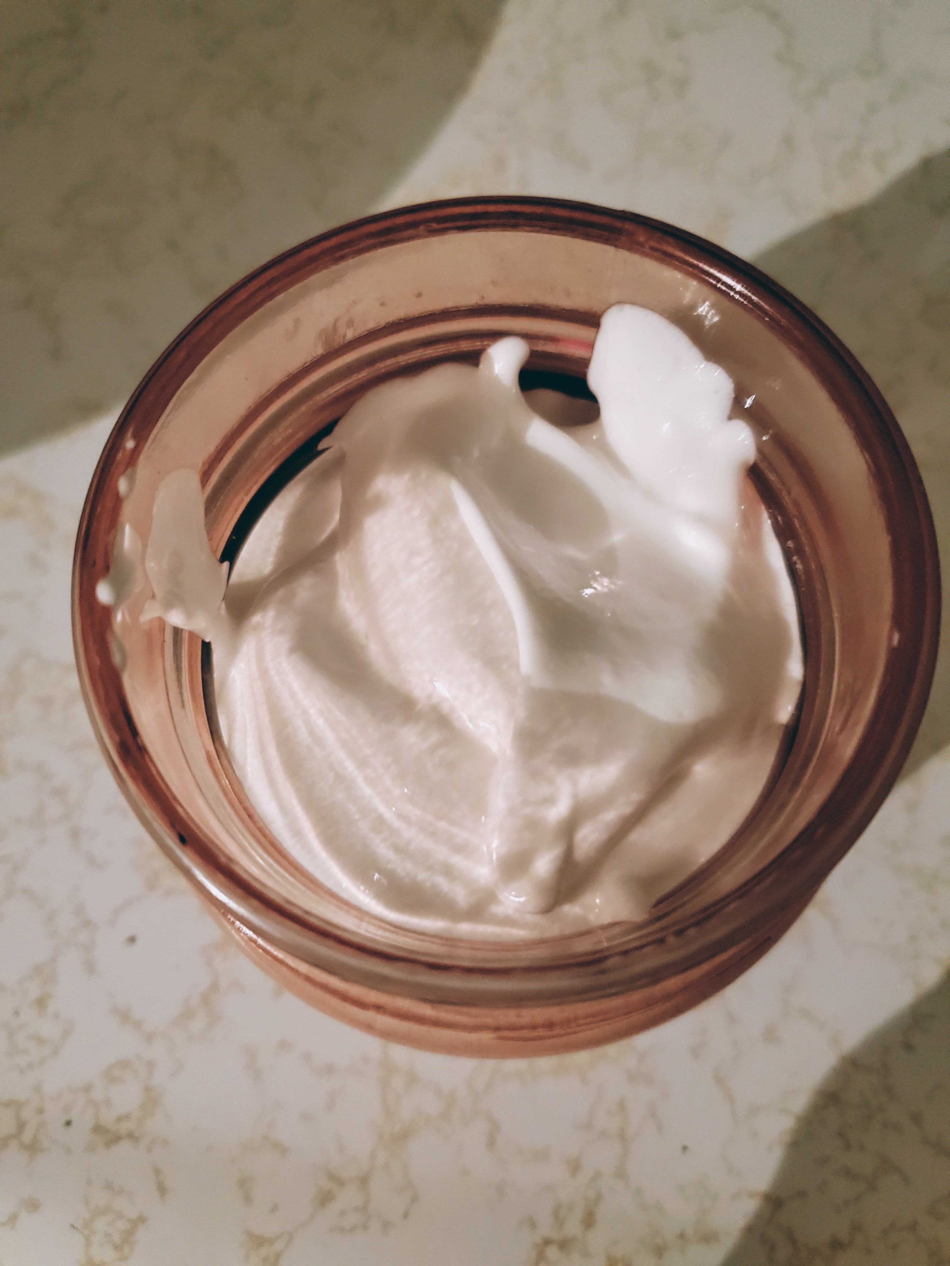Top view of open jar with homemade body butter