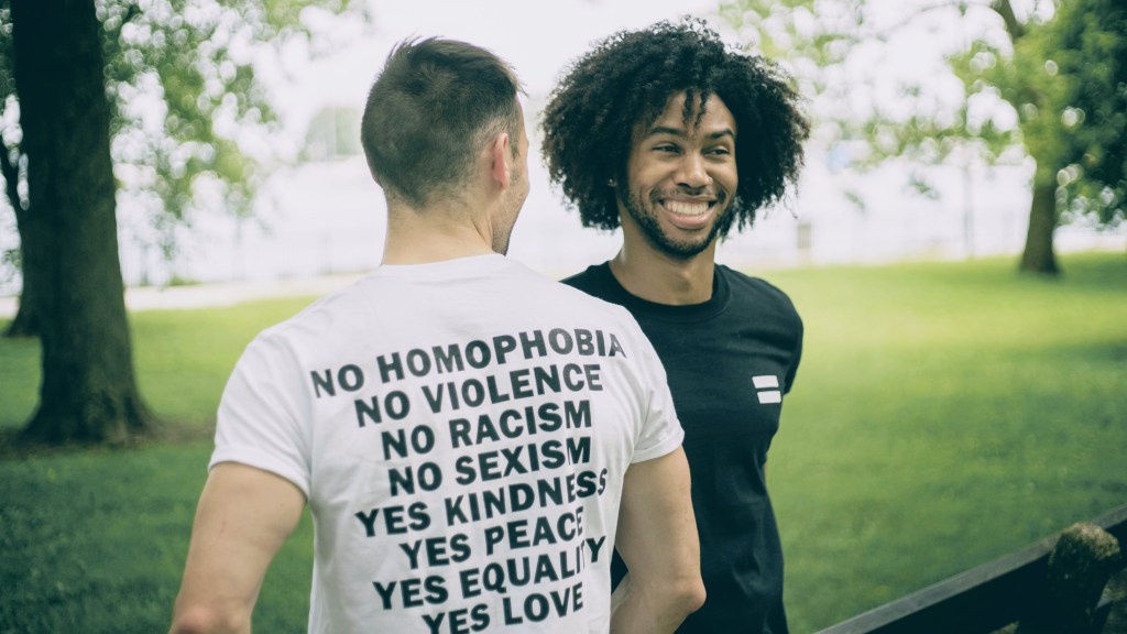 Two Men wearing kindness peace equality and love shirts