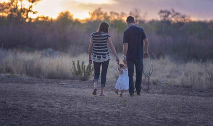 parents walking with child
